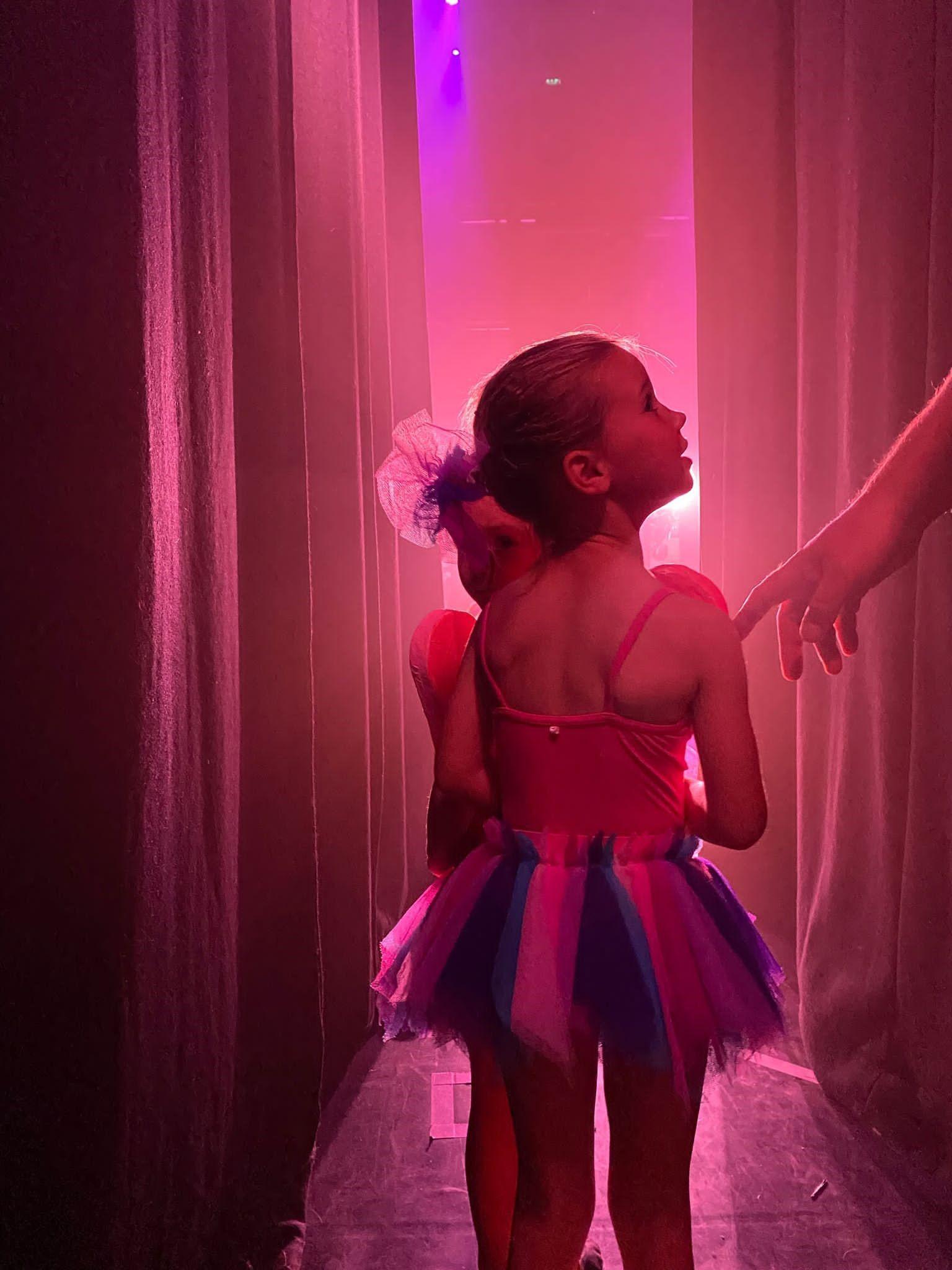 Jong meisje in tutu in de coulissen