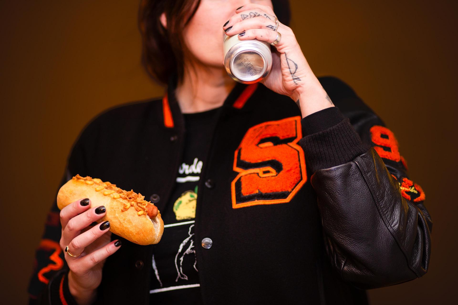 A Punk Dog (hotdog) with a can of Strip beer
