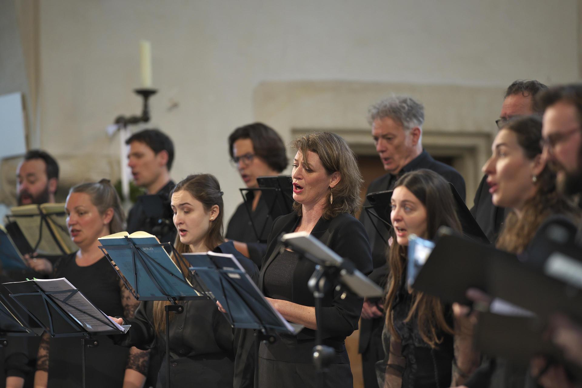 The orchestra plays music on stage.