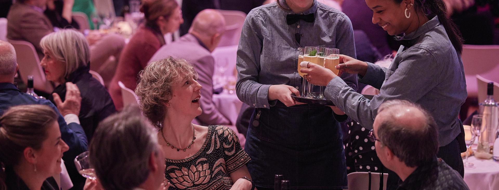 Medewerkers van PHIL delen drankje uit aan Founders